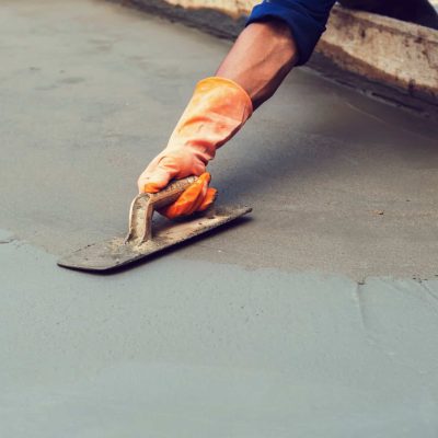 worker leveling concrete pavement for mix cement at construction