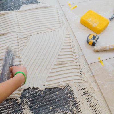 Floor tiles installation. Ceramic tiles and tools for home improvement, renovation